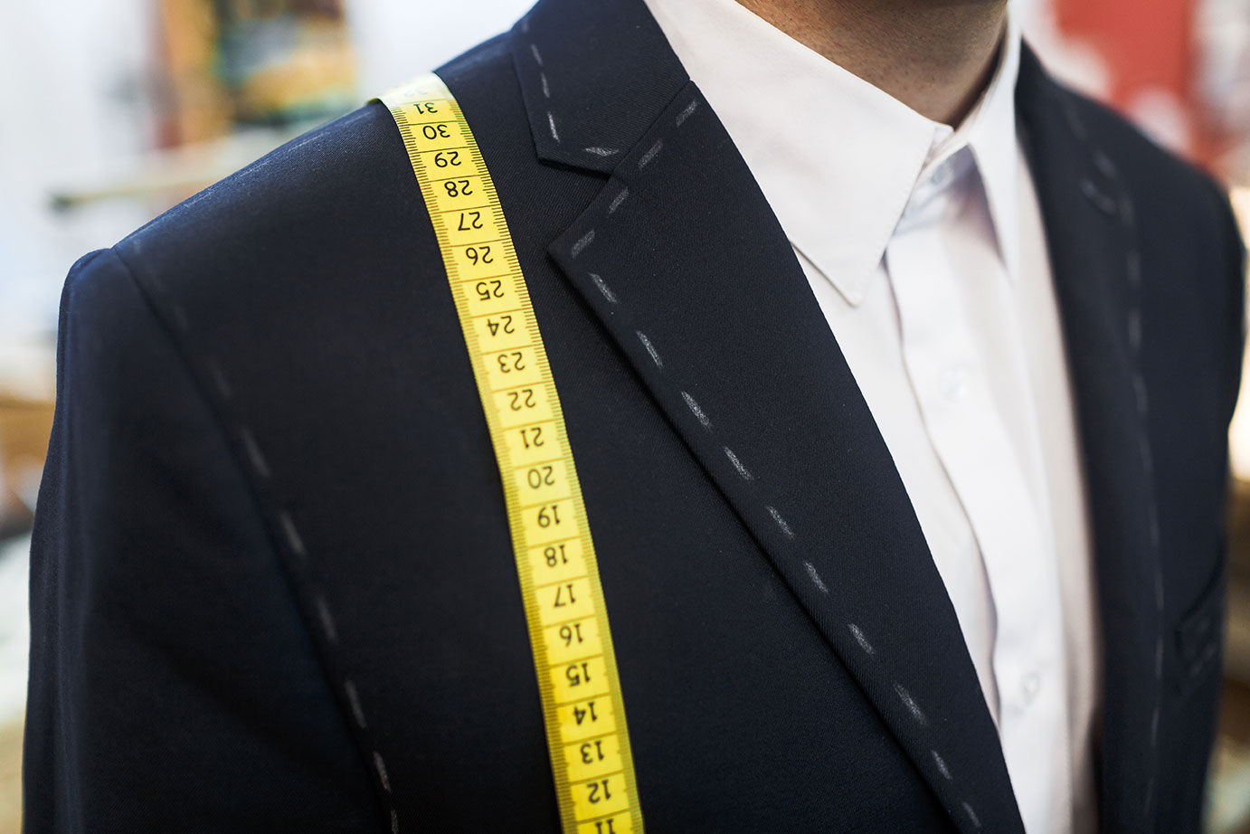 new-jacket-and-measuring-tape-on-businessman_rLWlNuBDRW